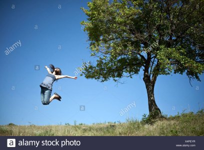 woman-jumping-by-tree-X4PEYR.jpg