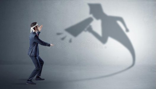 businessman-fighting-his-bossy-shadow-yelling-138195112.jpg