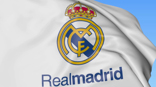 close-up-of-waving-flag-with-real-madrid-c-f-football-club-logo-seamless-loop-blue-background-...png