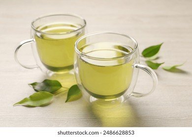 refreshing-green-tea-cups-leaves-260nw-2486628853.jpg